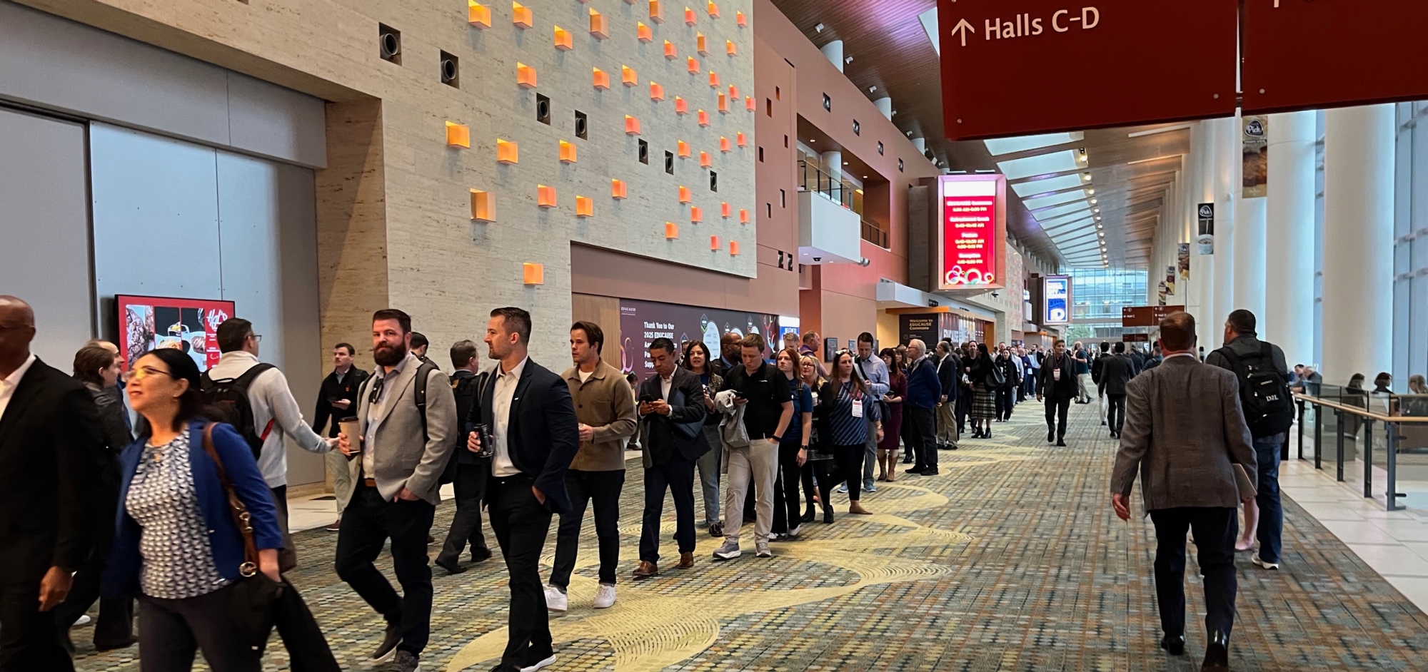 line of attendees entering a conference